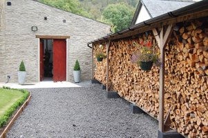 Firewood storage shed for biomass log boiler